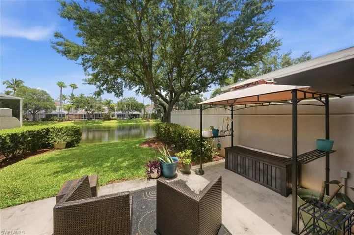 Private patio with a partial shade structure and concrete flooring