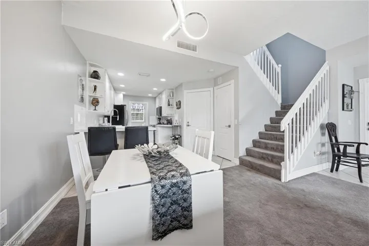Open-concept dining area with a modern linear light fixture