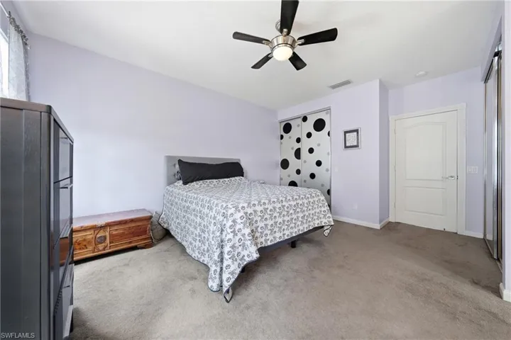 Room featuring sloped ceilings, light-colored wall paint, and plush carpeting
