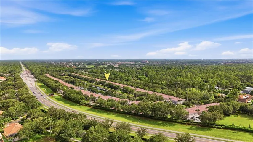 Aerial perspective showcasing a residential community amidst extensive green landscaping