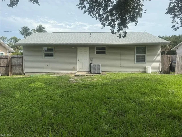 Back of property with a shingled roof
