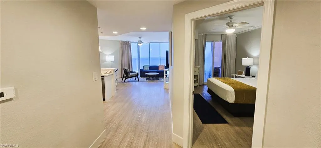 Hall with a water view and light wood-type flooring