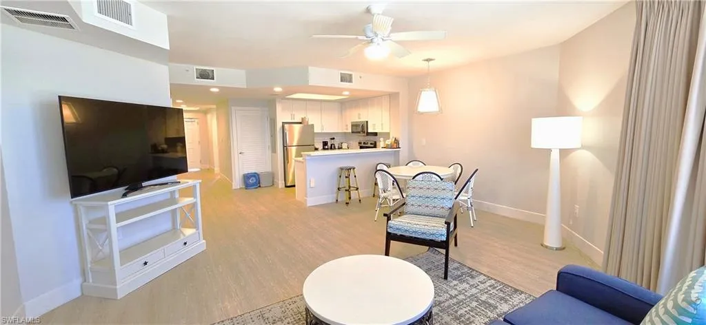 Living room with ceiling fan and light wood-type flooring
