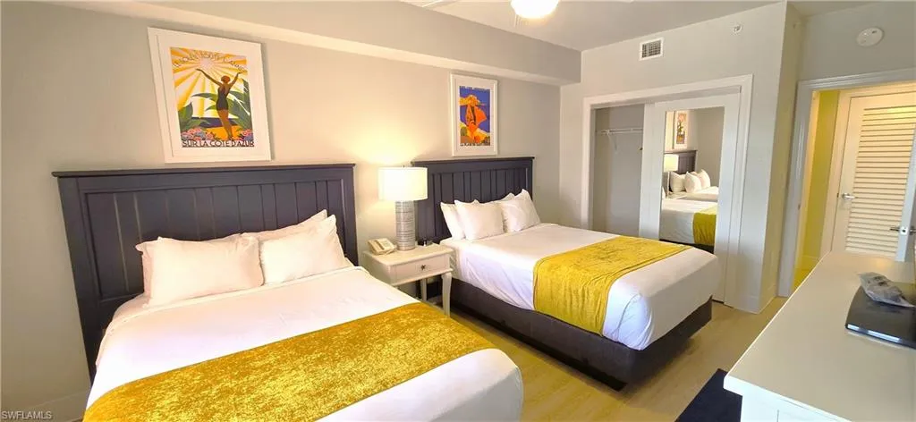 Guest Bedroom with light hardwood / wood-style flooring and a closet