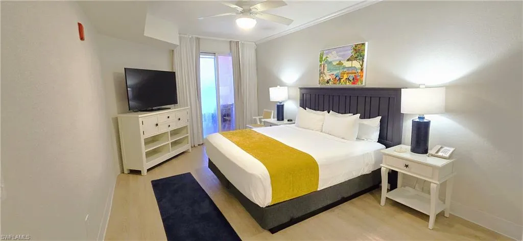 Primary Bedroom with ceiling fan, light hardwood / wood-style flooring, and ornamental molding