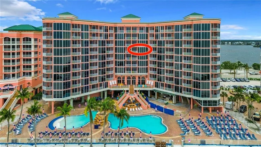 View of building exterior featuring a community pool
