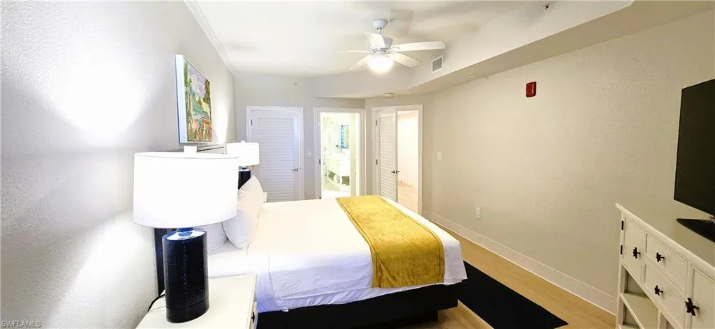 Bedroom with crown molding, light hardwood / wood-style flooring, and ceiling fan