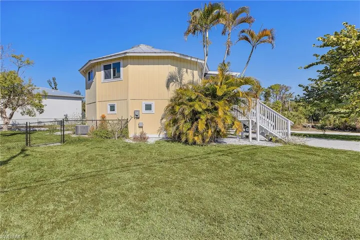 View of home's exterior featuring a gate and stairway