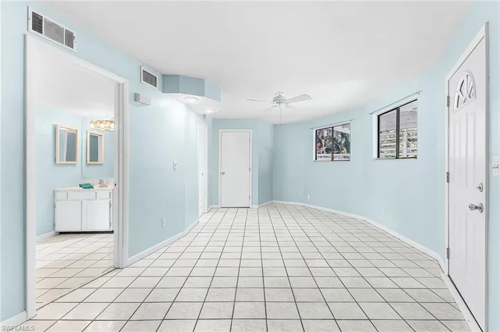 Unfurnished room with a ceiling fan and light tile patterned floors