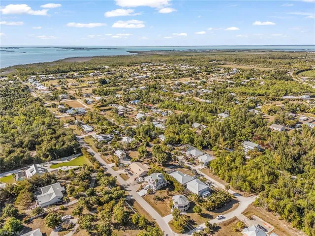 Aerial view of property's location with nearby suburban area and a nearby body of water