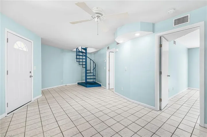 Entryway featuring ceiling fan and tile patterned flooring