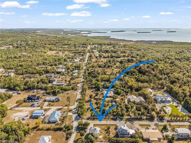 Aerial overview of property's location featuring nearby suburban area and a large body of water