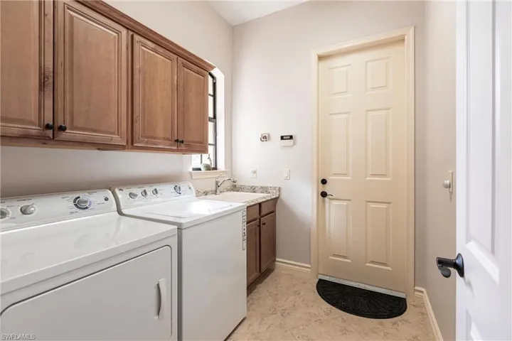 Off the back hallway by 2 guest bedrooms and garage