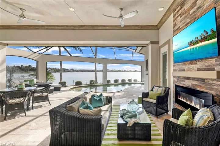 Sunroom featuring ceiling fan and a fireplace