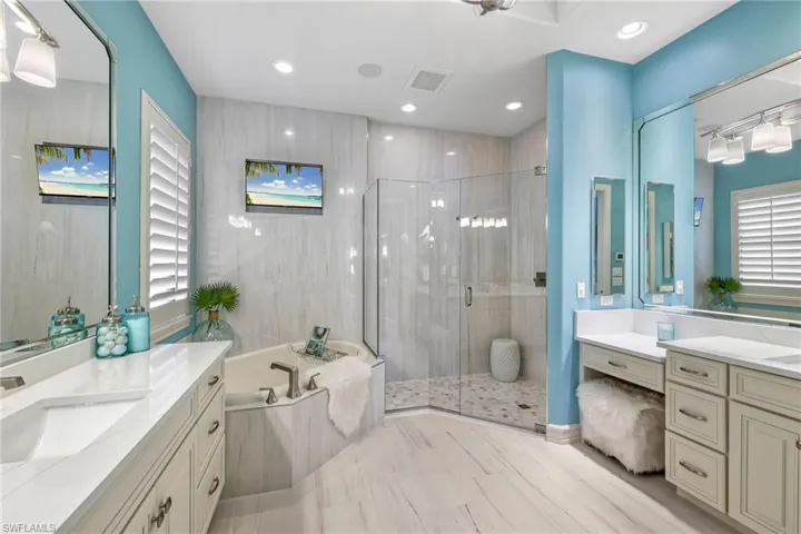 Bathroom with vanity and plus walk in shower