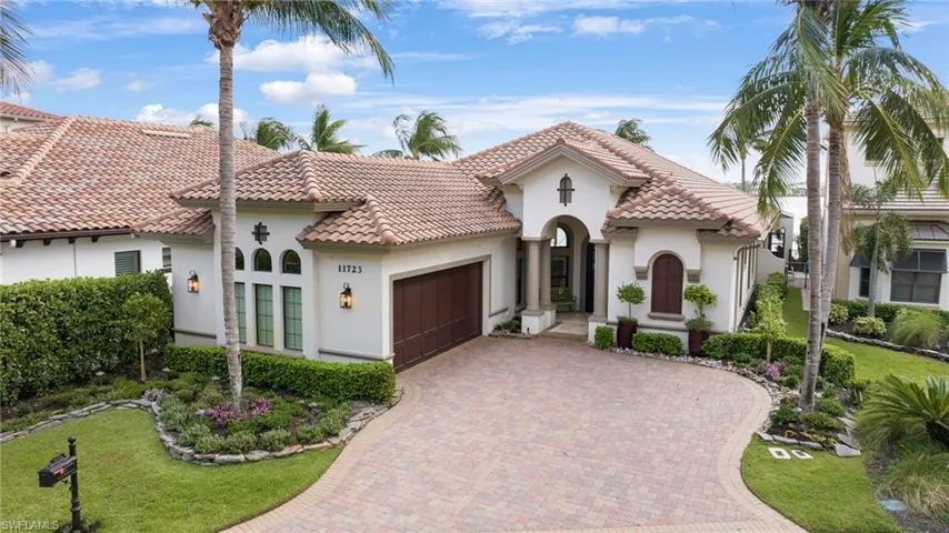 Mediterranean / spanish house featuring a garage and a front lawn
