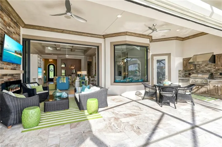 View of patio with an outdoor kitchen, area for grilling, an outdoor hangout area, and ceiling fan
