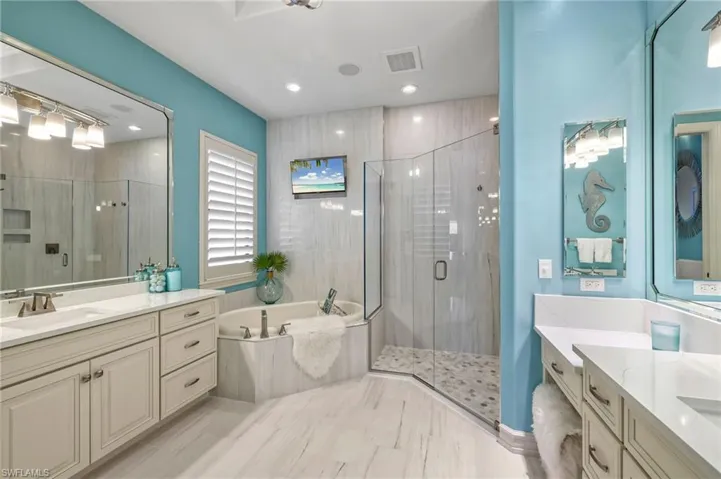 Bathroom with vanity and separate shower and tub