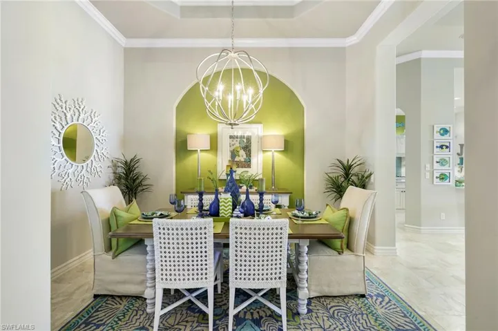 Dining room with crown molding and a chandelier