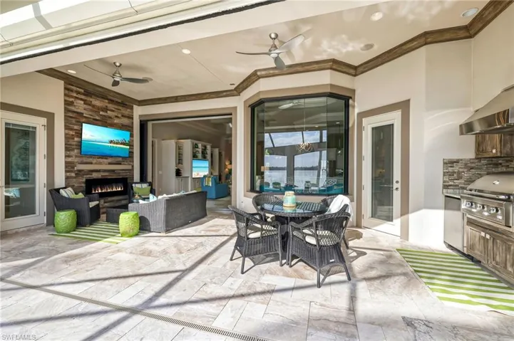View of patio featuring ceiling fan, an outdoor hangout area, and grilling area