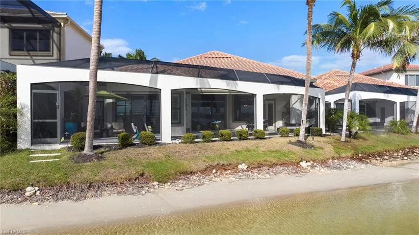 Rear view of property featuring glass enclosure