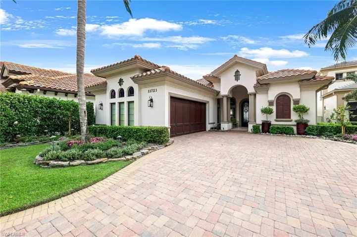 Mediterranean / spanish-style home with a garage