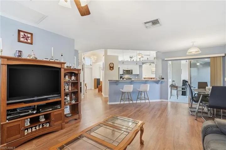Living area with a ceiling fan and light wood-type flooring