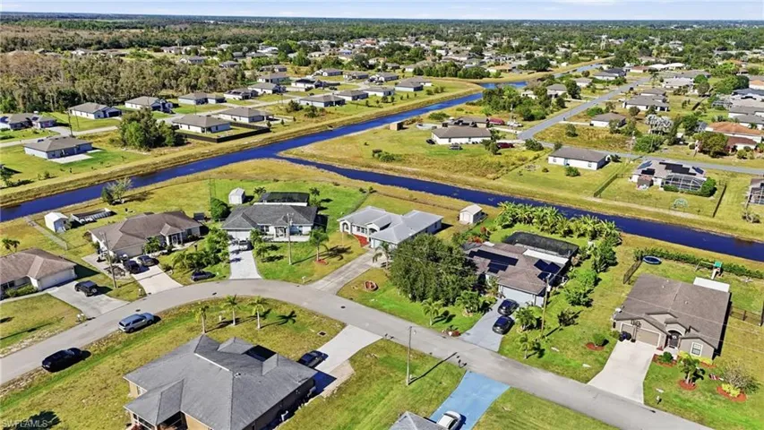 Aerial view of residential area featuring a large body of water