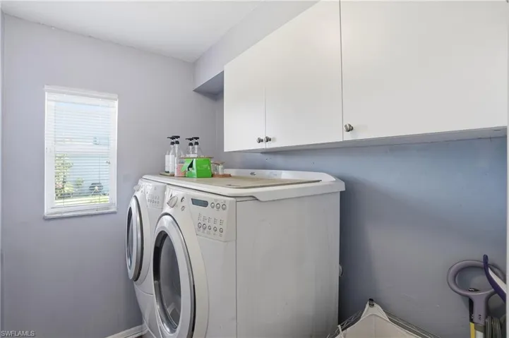 Laundry area with cabinet space and washing machine and dryer