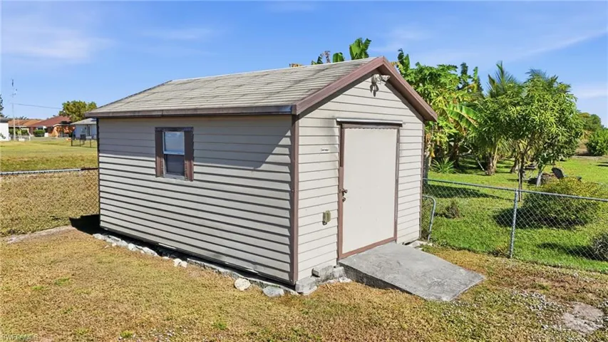 View of shed with a fenced backyard