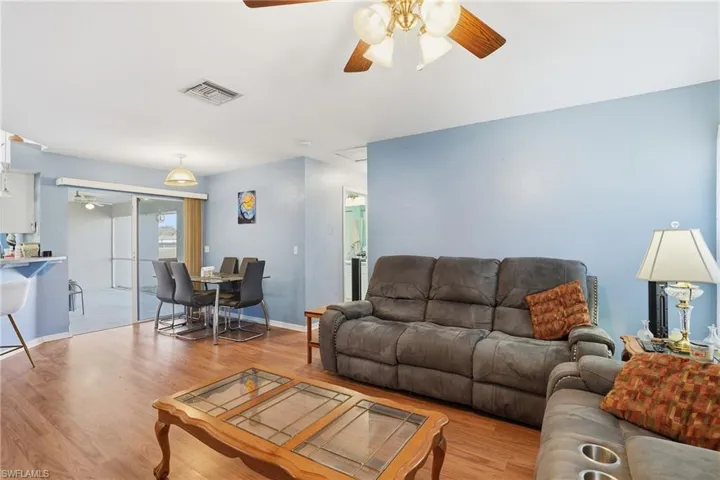 Living area featuring a ceiling fan and light wood-style floors