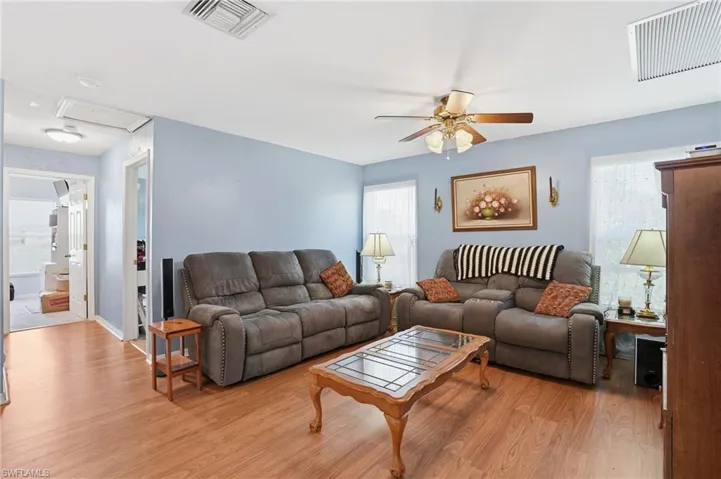 Living room with wood finished floors and ceiling fan
