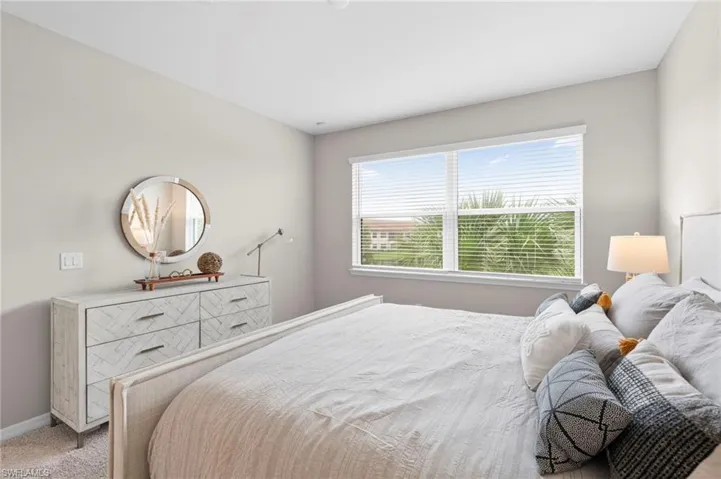 Bedroom featuring carpet floors and baseboards
