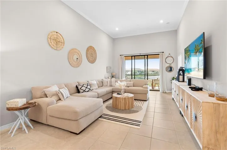 Living area featuring ornamental molding, light tile patterned floors, and recessed lighting