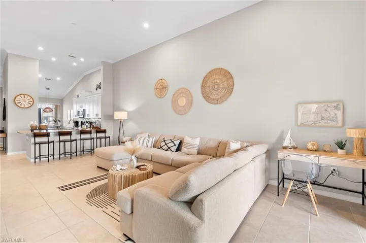Living room featuring recessed lighting, light tile patterned floors, and crown molding