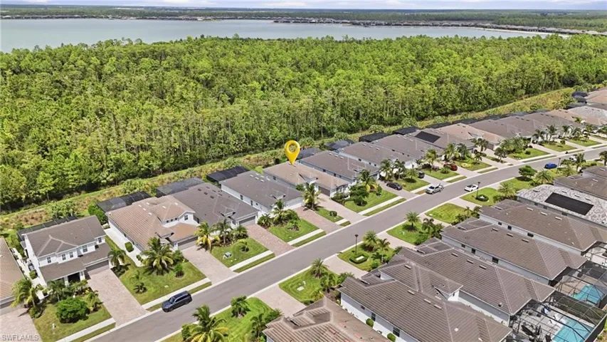 Neighborhood featuring a paved street, uniform residential properties, and landscaping