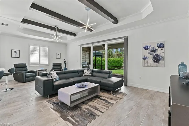 Tray ceiling with dark wood-finish beams, recessed lighting, and contemporary ceiling light fixtures