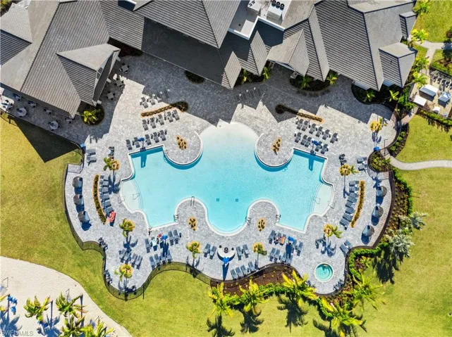 Expansive resort-style swimming pool featuring a tanning ledge and integrated spa