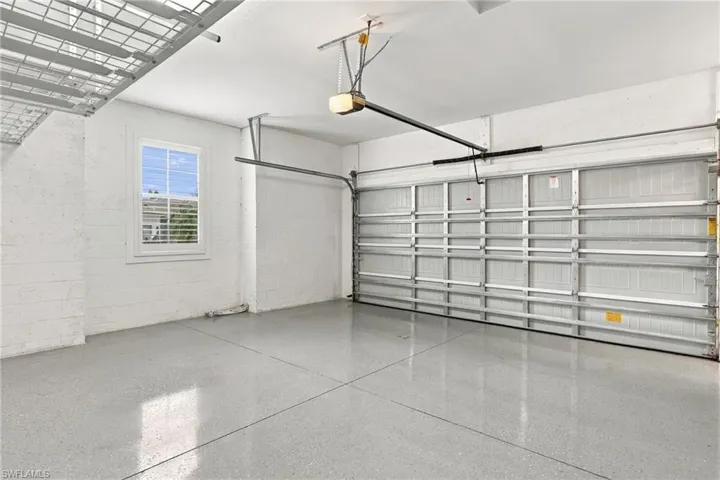 Garage with a window, overhead storage rack, and a finished floor surface