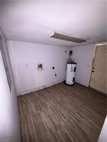 Laundry room featuring water heater and washer hookup