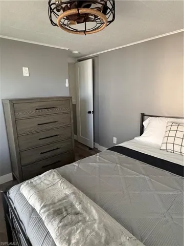 Bedroom with ornamental molding and a textured ceiling