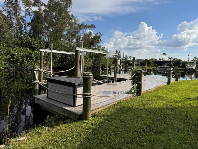 Dock area featuring a yard and a water view