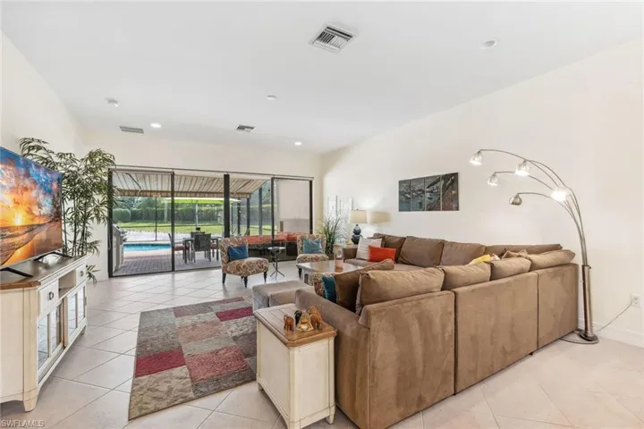 Great room area with sliders to the pool and lanai