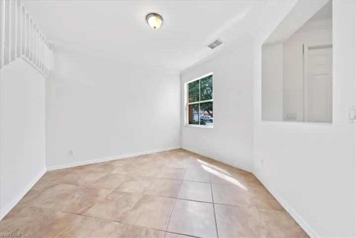 Tiled spare room with ornamental molding