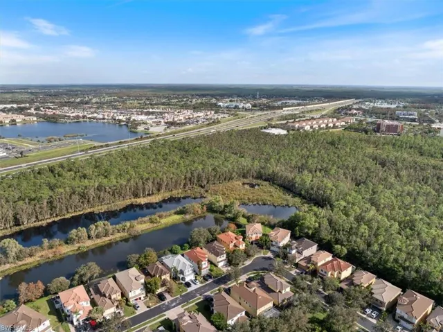 Birds eye view of property with a water view