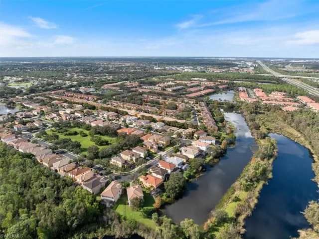 Birds eye view of property with a water view