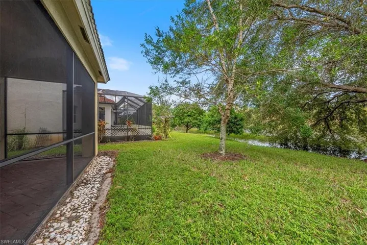 View of yard with glass enclosure