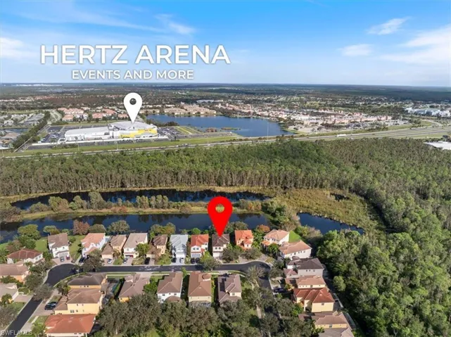 Birds eye view of property with a water view