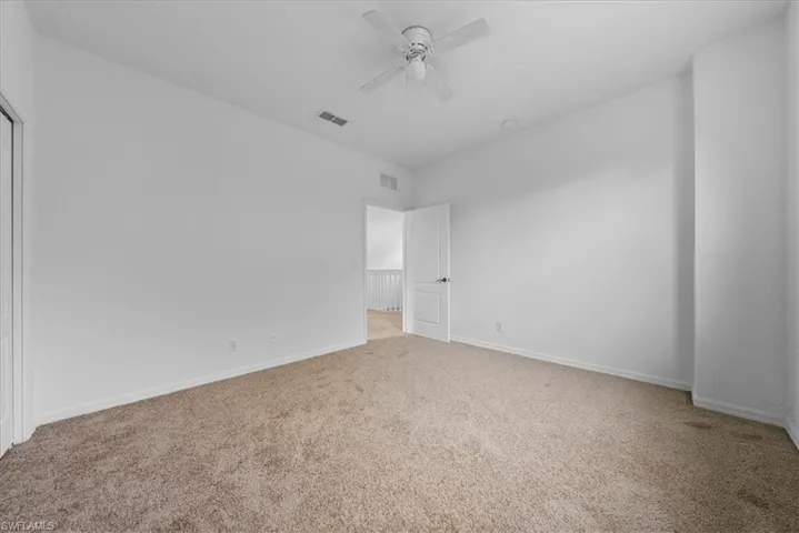 Unfurnished bedroom featuring ceiling fan and carpet flooring