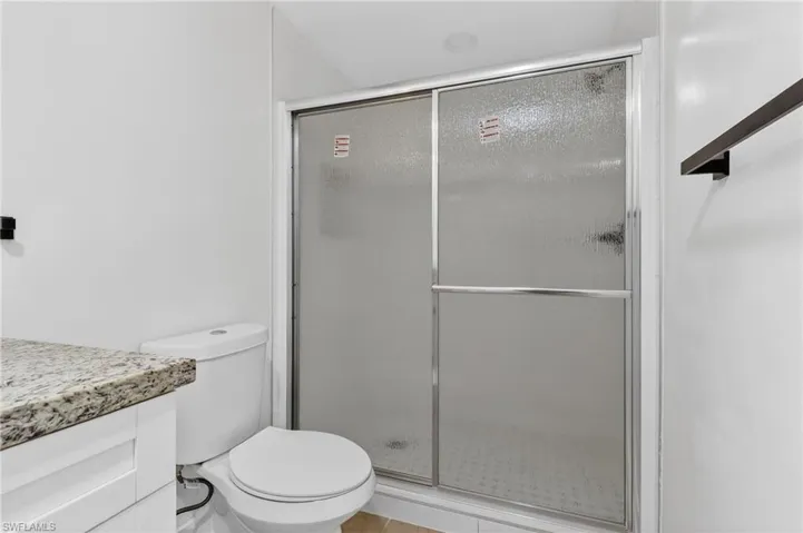 Bathroom featuring vanity and a shower stall